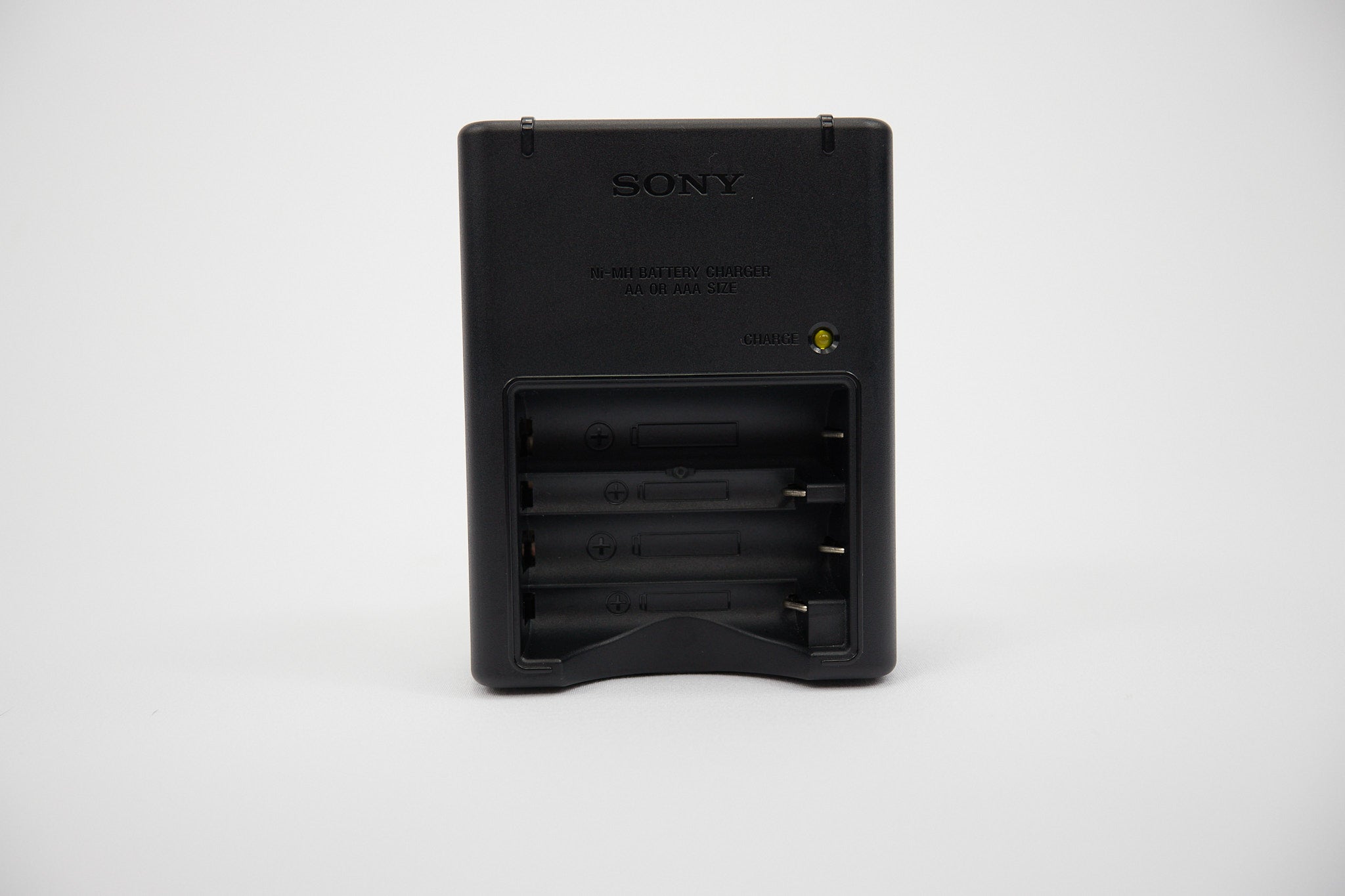 Black Sony battery charger on a white background