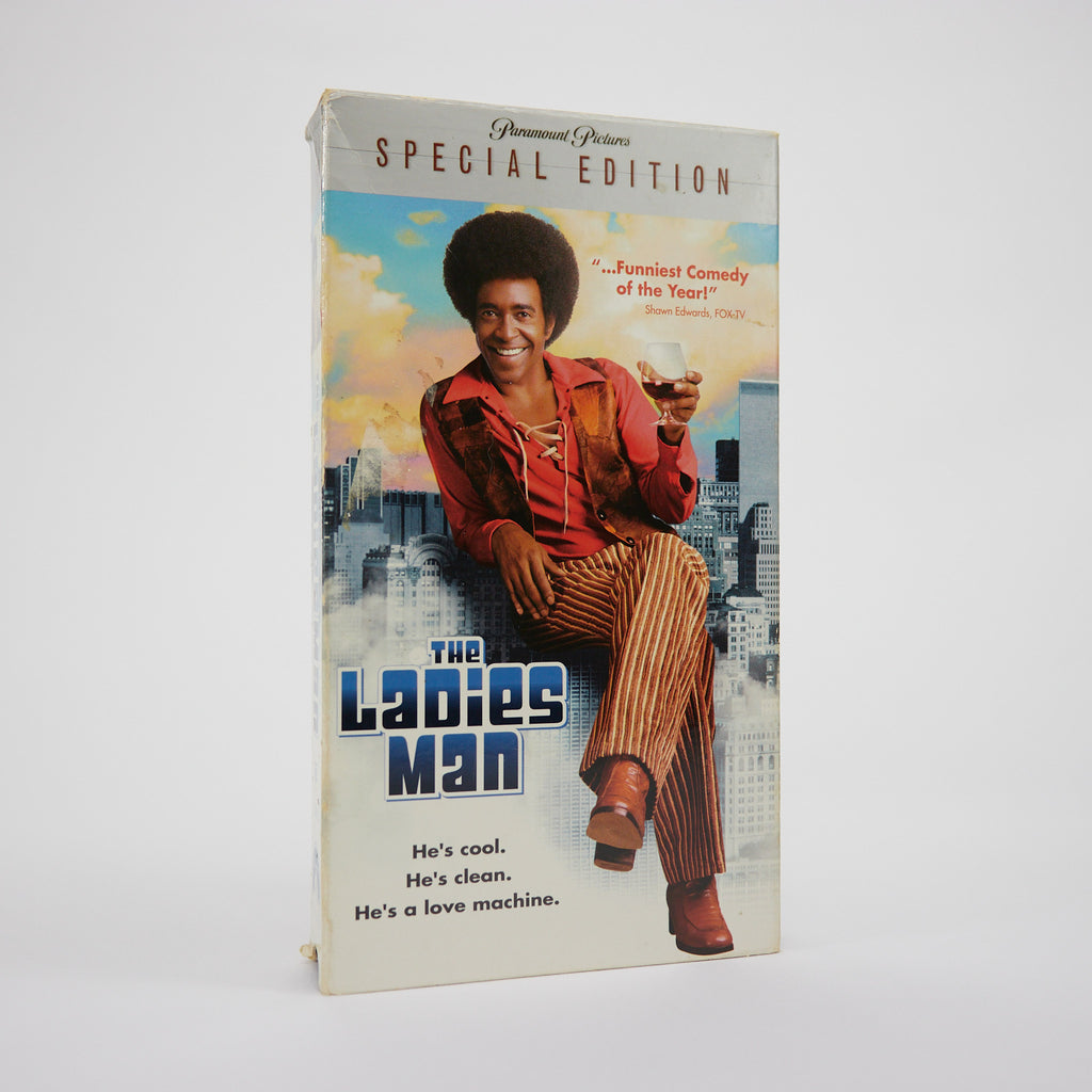 VHS tape cover of 'The Ladies Man' with a man sitting on a building edge.